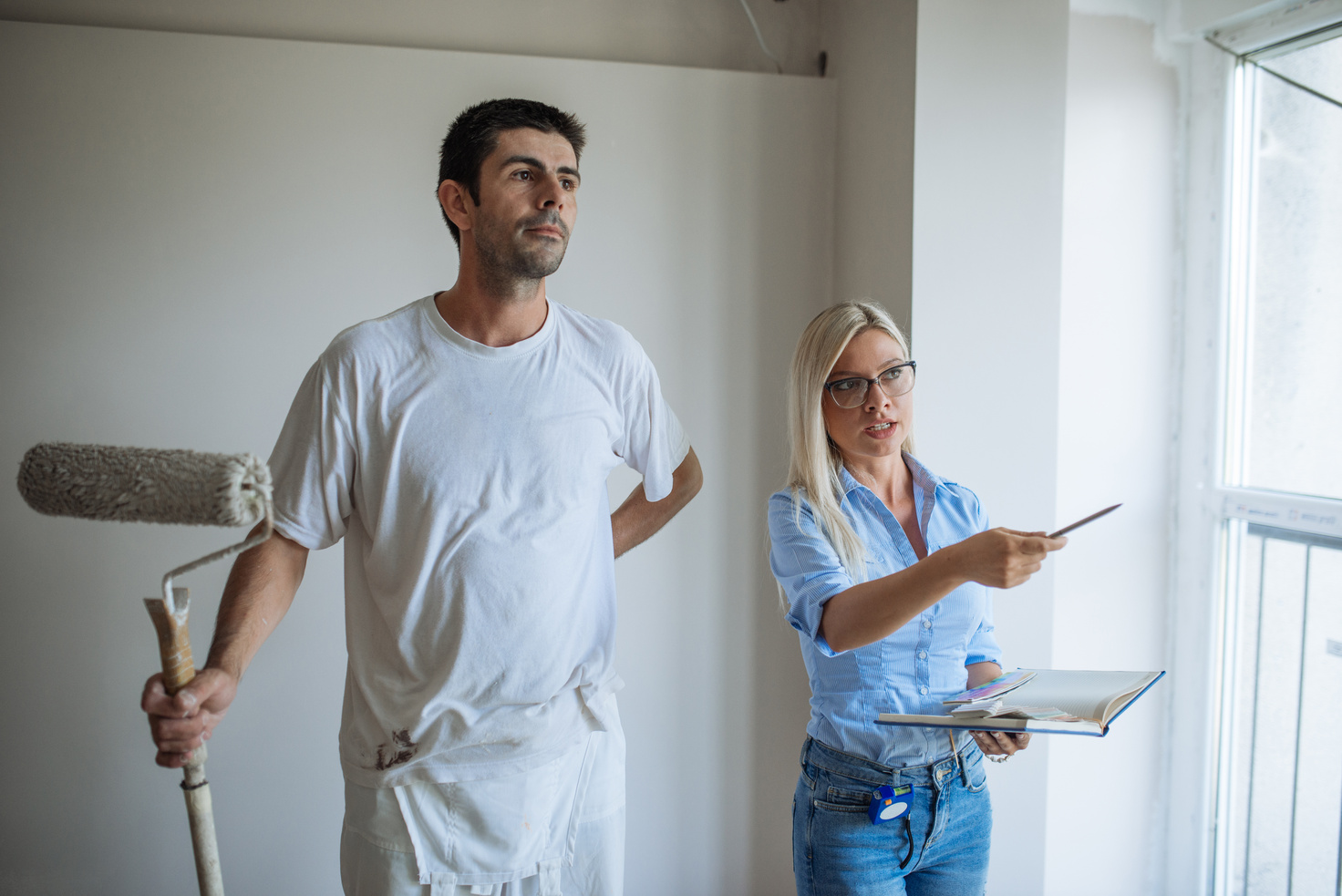 Property manager discussing with painter