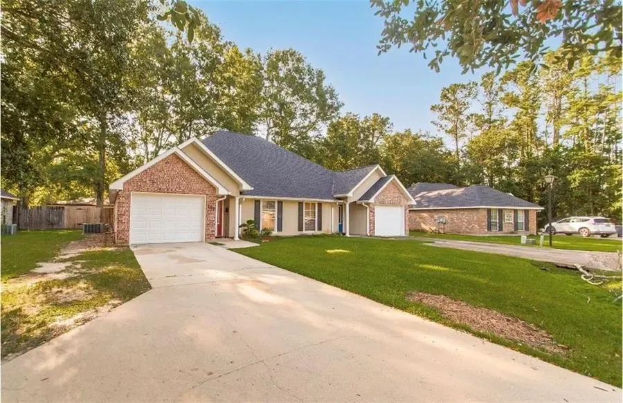 Brick ranch home exterior with mature trees, southeast Louisiana